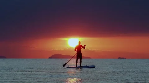 Tropical sunset with silhouette on SUP Stock Footage 331124162