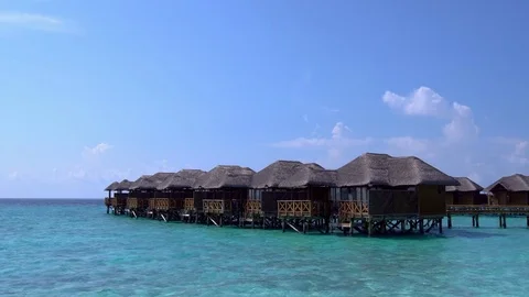 Tropical travel card with water bungalows Stock Footage