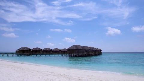 Tropical travel destination with pristine beach and water bungalows Stock Footage