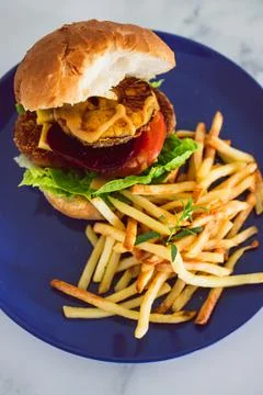 Tropical vegan burger with pineapple beetroot tomato and plant-based patty wi Stock Photos