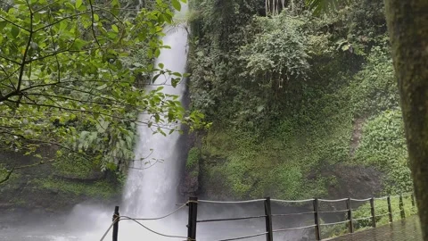 Tropical Waterfall Cascading Down Cliff, Jungle Greenery Reveal Pan Shot 스톡 동영상 324496727