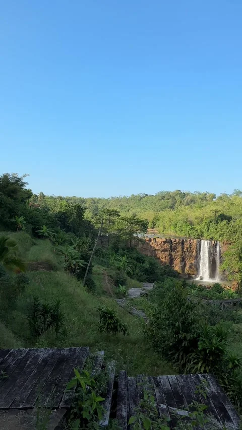 Tropical Waterfall Cascading Down Cliff in Lush Jungle, Vertical Pan Shot 스톡 동영상 324769418