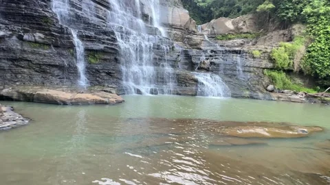 Tropical Waterfall Cascading Down Rock Layers, Green Pool, Medium Shot Stock Footage 324771385