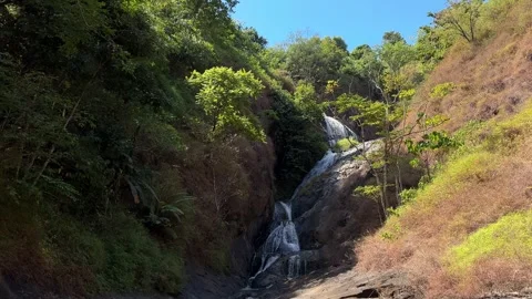 Tropical Waterfall Cascading Down Rocky Slopes, Forest Stream, Revealing Shot Video stock 324769834