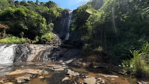 Tropical Waterfall Cascading Down Rocky Terrain, Lush Jungle Panorama Stock Footage 325646695