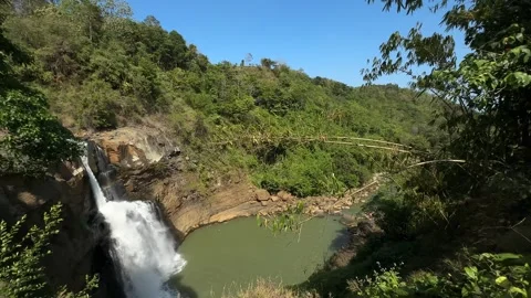 Tropical Waterfall Cascading into Green Pool, Lush Jungle Landscape, Wide Shot Video stock 324771409