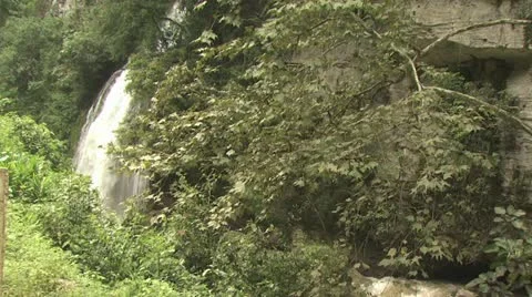 Tropical Waterfall Spilling Into A River 스톡 동영상 19226233