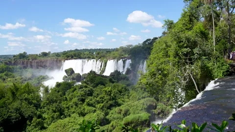 Tropical waterfalls surrounded by exotic forest and lush greenery Видео 337496013