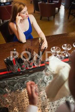 Troubled attractive woman having a flute of champagne Stock Photos
