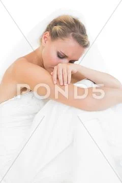 Troubled blonde bride sitting on floor Stock Photos