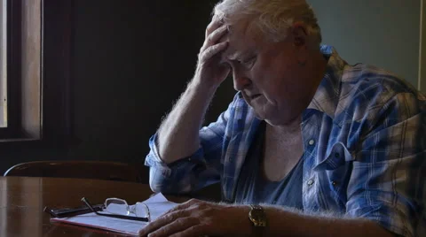 Troubled elderly man with head in hands looking sad and stressed Stock Footage 67340503