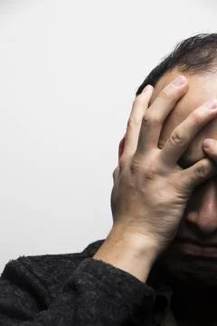 Troubled man on a white background Stock Photos