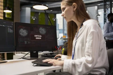 Troubled software developer reviewing error logs at work Fotos de archivo