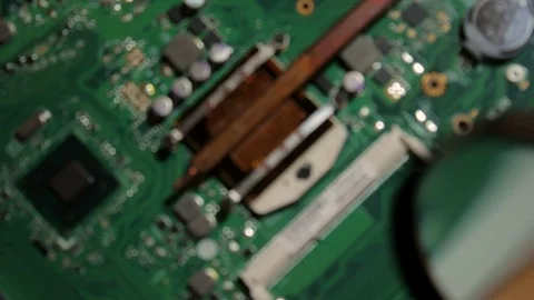 Troubleshooting components of the CPU with a magnifying glass Stock Footage