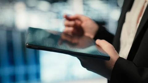Troubleshooting, tablet closeup and admin in data center Stock Photos
