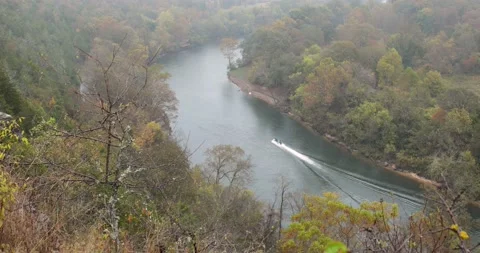 Trout boat makes it's way upriver on a rainy cold day Stock Footage 142104497