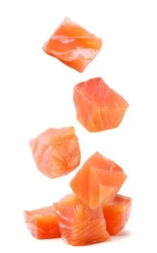 Trout cubes fall on a pile on a white background. Isolated Stock Photos