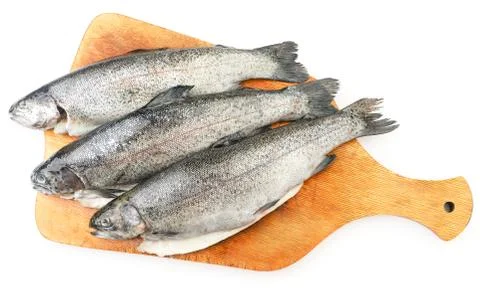 Trout on kitchen board on white background, isolated. The view from top Stock Photos