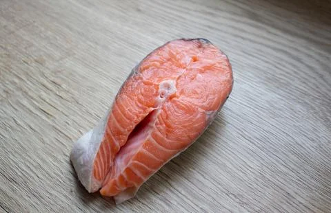 Trout steak lying on a cutting board close-up Stock Photos