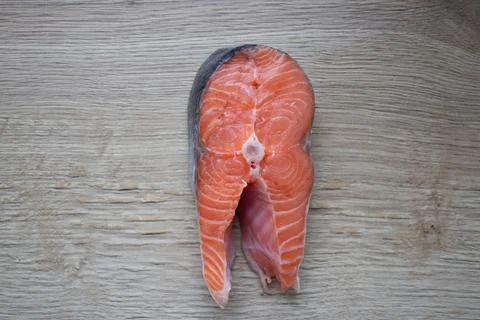 Trout steak lying on a cutting board close-up Stock Photos