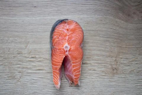 Trout steak lying on a cutting board close-up Stock Photos