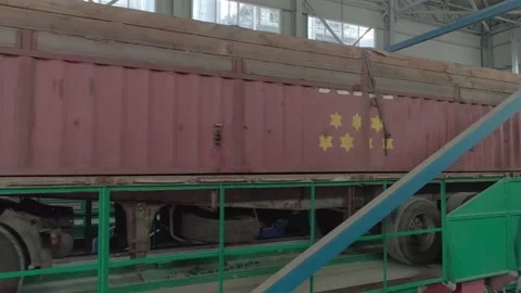 Truck arrives at the elevator lifting device to unload the grain of the new crop Stock Footage 147668952