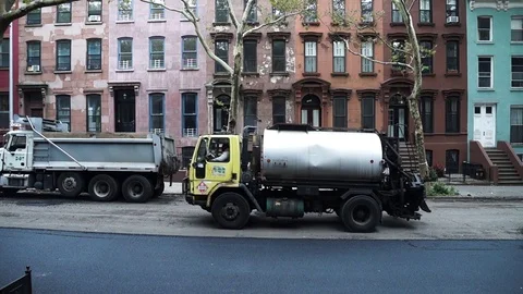 Truck backing up and driving off during road paving of city street Stock Footage 80206596