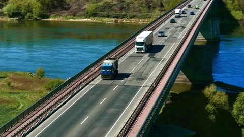 Truck with cargo van trailer driving on bridge. Lorry with box trailer moving Stock Footage 320409575