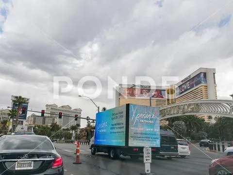 Truck with commerical advertisement on the road with Mirage casino as backgro Stock Photos