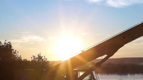 Truck crane against the backdrop of the setting sun Stock Footage 76833792