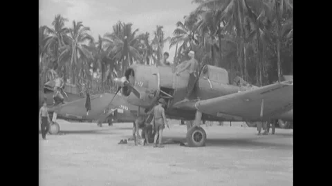 A truck delivers bombs wrapped with shells that are then attached to a warplane Stock Footage 101647752