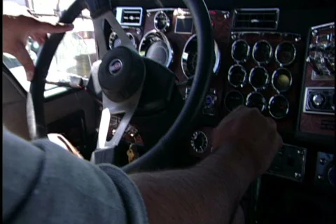 Truck driver backs up truck Stock Footage