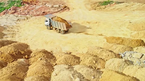 Truck driver dumping sand at one place in construction area in telangana Stock Footage 301672556