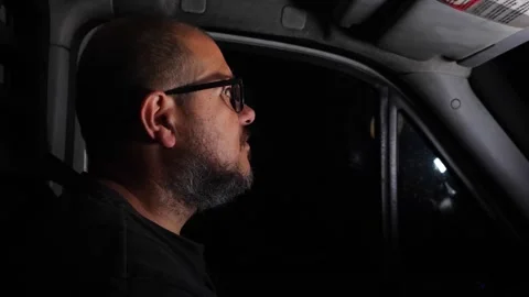 Truck driver focused while driving at night on a long highway route Stock Footage 318581990