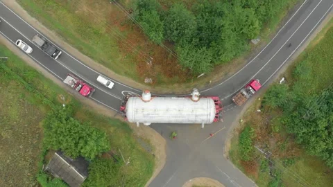 A truck driver with an oversized cargo drives along an intercity highway. 库存影片 147536668