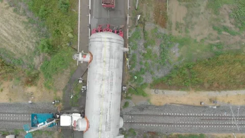 A truck driver with an oversized cargo drives along an intercity highway. 库存影片 147536741
