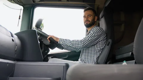Truck driver preparing for the next destination. Right hand drive car Stock Footage 251840629