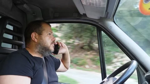 Truck driver talking on the phone while driving. Dangerous behavior Stock Footage 289001526