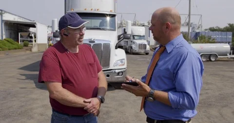 Truck driver talks to official with electronic notepad 4K Video stock 79953174