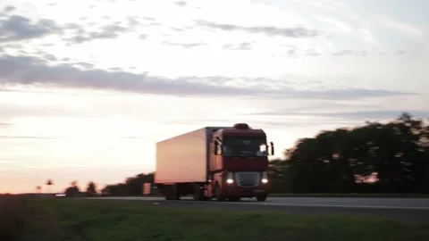 Truck driver transports cargo on a truck with a semitrailer against the backdrop Stock Footage 158382104