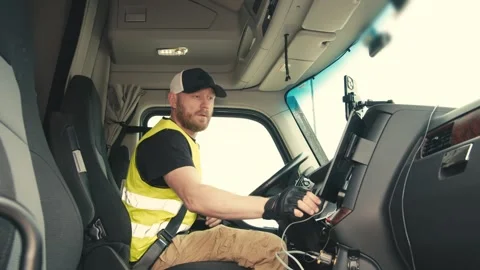 Truck driver using touchscreen navigation in cabin 動画素材 348179155