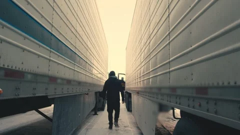 Truck driver walking between semi trailers Stock-Footage 347100143
