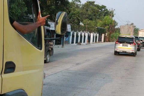 A truck driver waves while being photographed Stock Photos