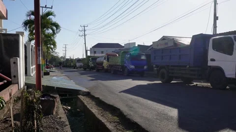Truck Drivers Waiting in a Long Queue Amidst a Fuel Crisis in Indonesia Stock Footage 318997312