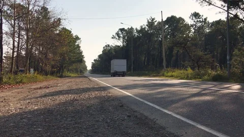 Truck driving and transporting on empty highway Stock Footage 82427687
