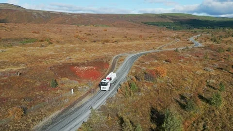Truck driving on an empty road trough Icelandic highlands - Autumn in Iceland Stock Footage 233035216