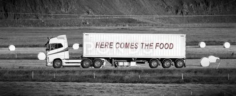 Truck driving through a rural area - Here comes the food Stock Photos