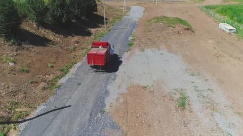A truck is driving to unload garbage into an empty landfill. Aerial top view Stock Footage 272586306