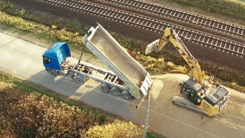 Truck full of sand unloading at construction site aerial shot Stock Footage 97798238