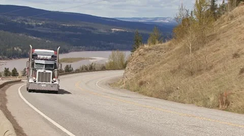 Truck Hauling Heavy Load Uphill in B.C., Canada Stock Footage